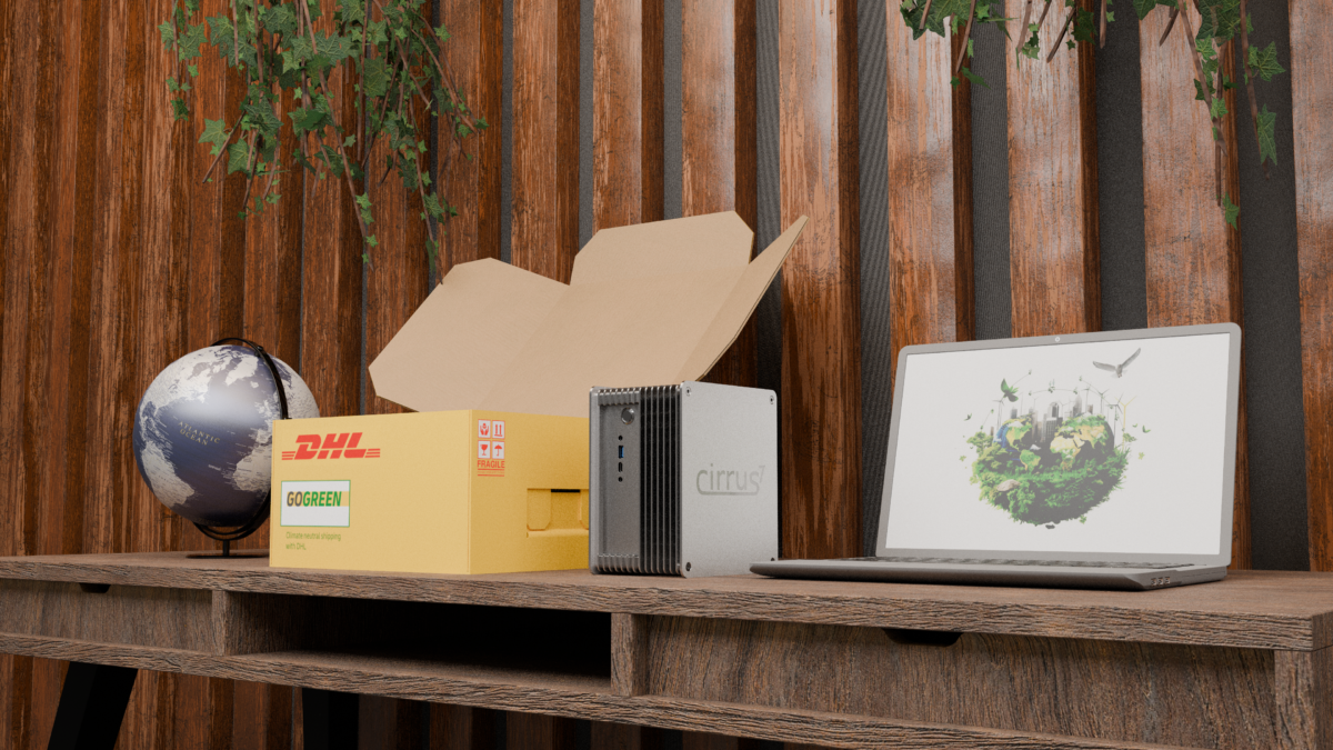 A product shot of a Cirrus7 system next to a DHL GoGreen box, a globe, and a laptop displaying an eco-friendly image. The setup suggests a commitment to sustainability.